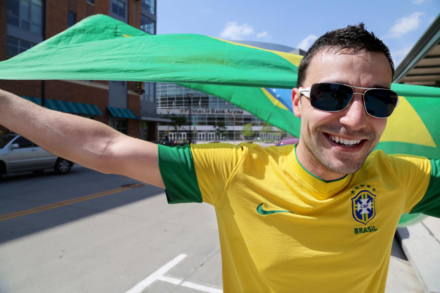 A student holds the Brazilian flag in Lincoln's downtown area.