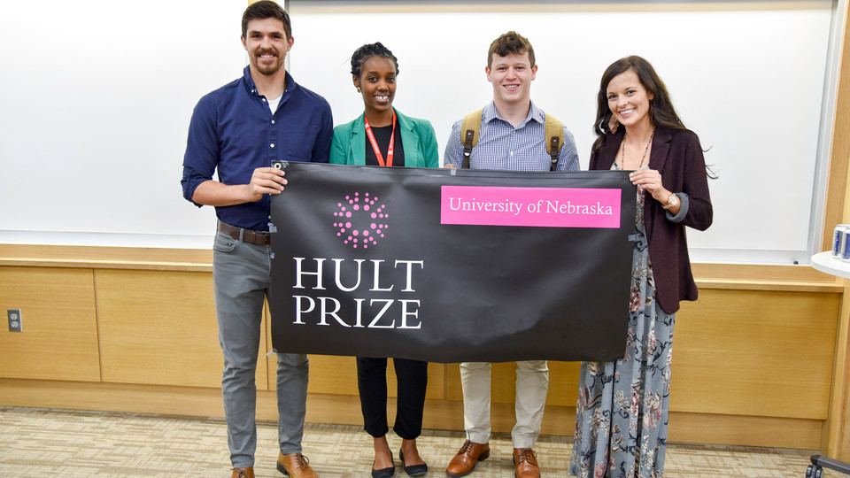 After being chosen to represent Nebraska at a regional contest in Boston, winning team Uhusiano poses with Hult Prize director Gloria Mwiseneza. From left, Matthew Brugger, Mwiseneza, Eli Wolfe and Cheyenne Gerlach.