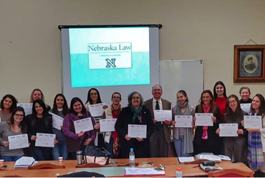 Students proudly holding their course certificates, along with Professor Lepard and Professor Claudia Lima Marques of UFRGS, who helped organize the course:
