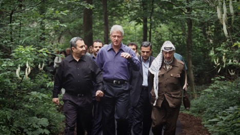 Leaders (front, from left) Ehud Barak, Bill Clinton and Yasser Arafat walk during Israeli-Palestinian peace talks at Camp David in July of 2000. 
