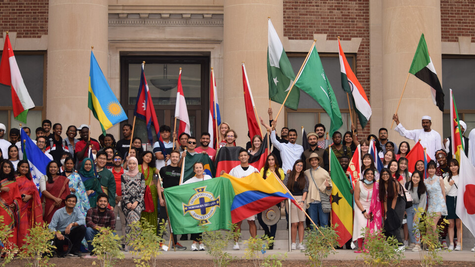 International students from around the countries hold their homeland flags as in Homecoming 2021