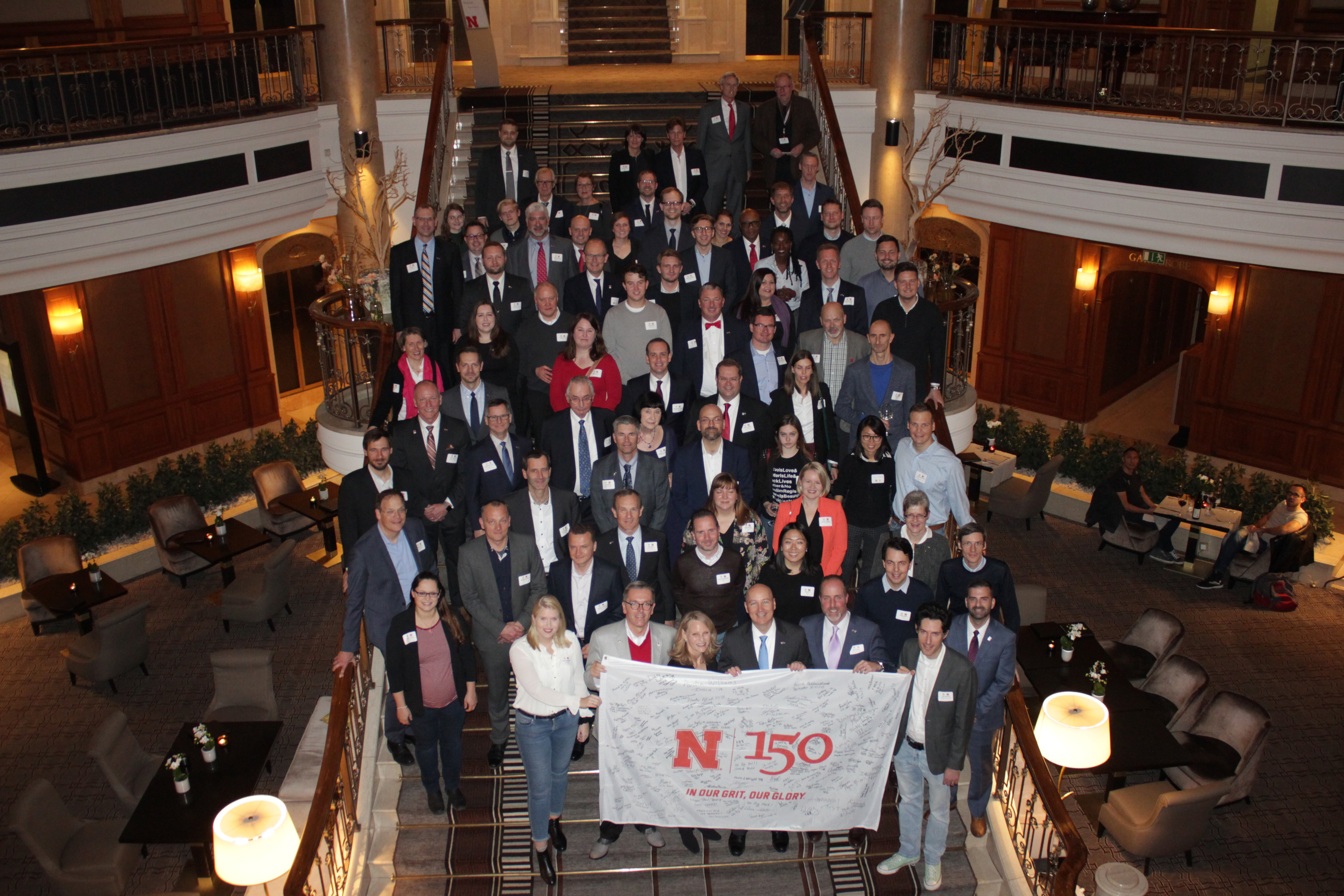 Participants from the Friends and Alumni Reception in Berlin, Germany on November 11 stand with the N150 flag in honor of UNL’s 150th anniversary.
