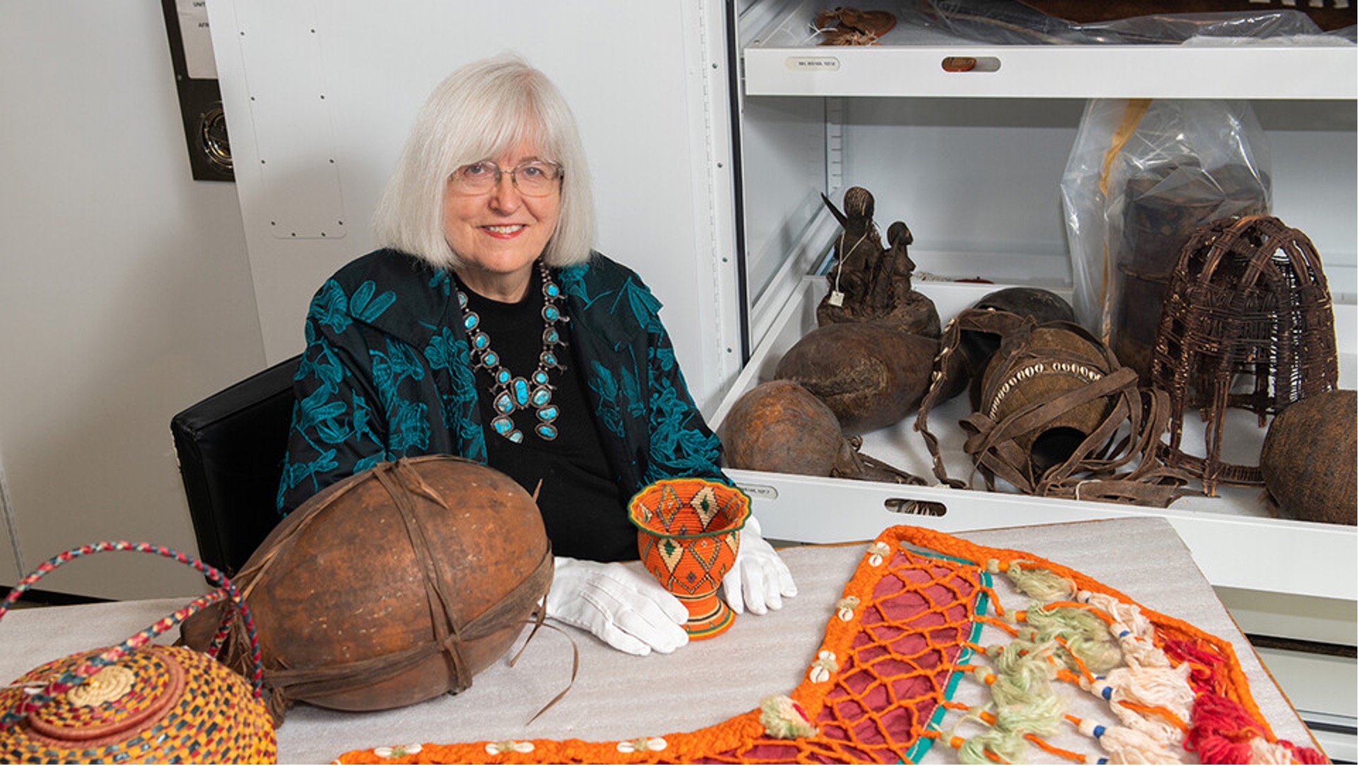 Priscilla Grew, director emeritus of the University of Nebraska State Museum, surrounded by artifacts from Egypt, Ethiopia, Sudan and Tanzania.