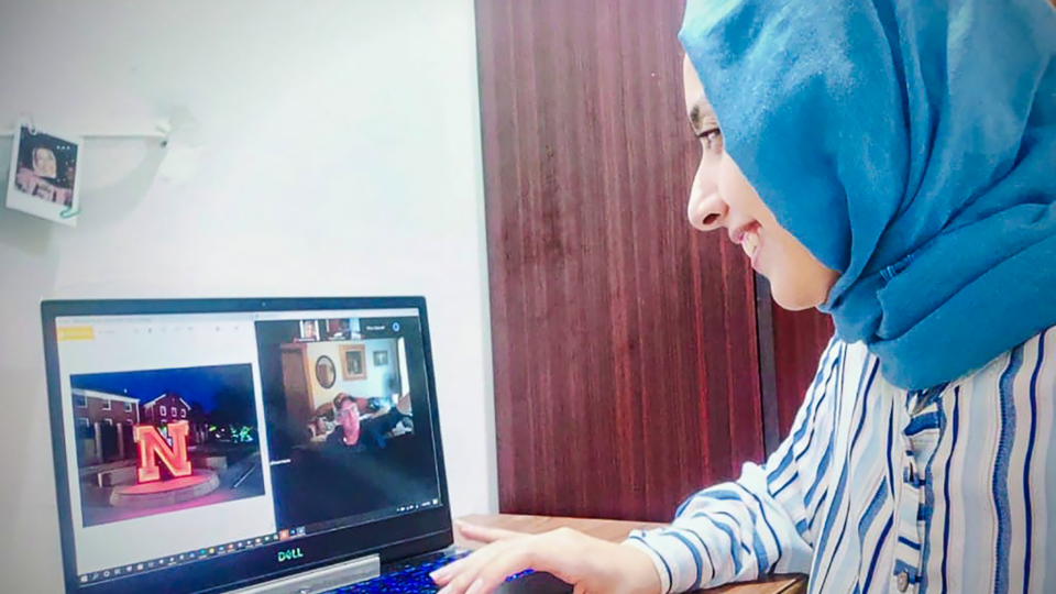 Egyptian student looks at her Zoom screen while connecting with faculty in Nebraska