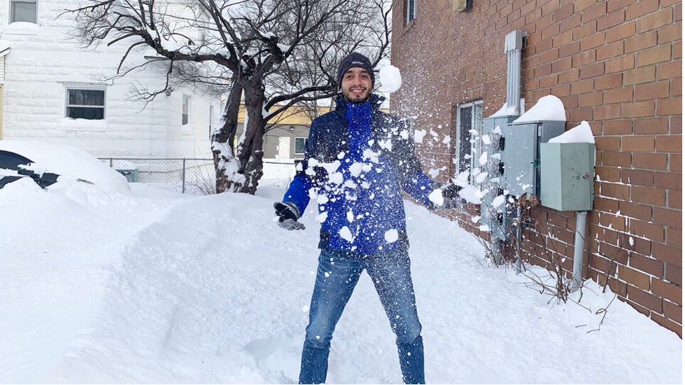 Juan Jiménez, a master's student in the Department of Agronomy and Horticulture, plays with snow for the first time. Jiménez arrived at Nebraska from Colombia Jan. 22.