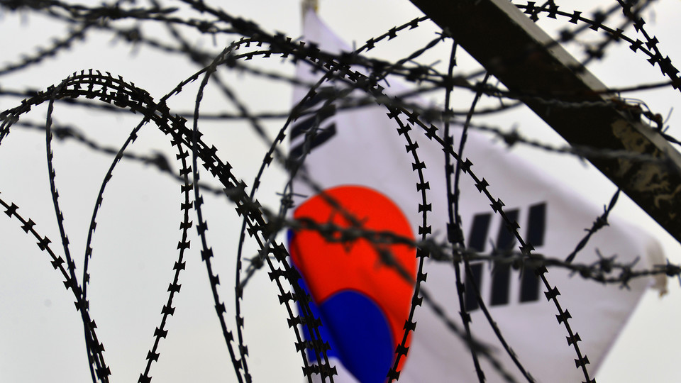 Razor wire frames the South Korean flag at the border with North Korea. OLLI's annual Winter Lecture series will examine the history of the Korean Peninsula.
