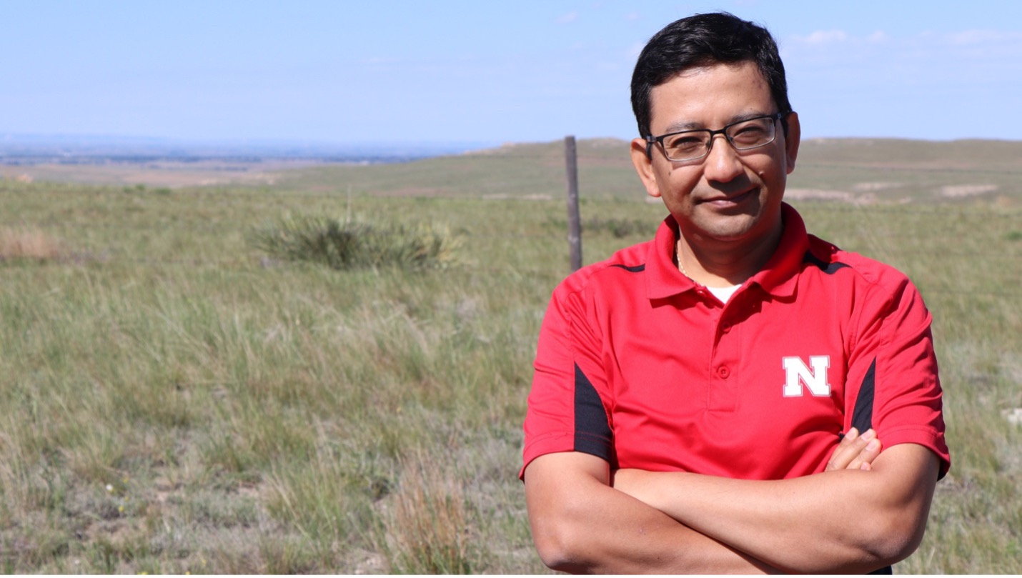 Bijesh Maharjan stands near a pasture north of Scottsbluff, Nebraska.