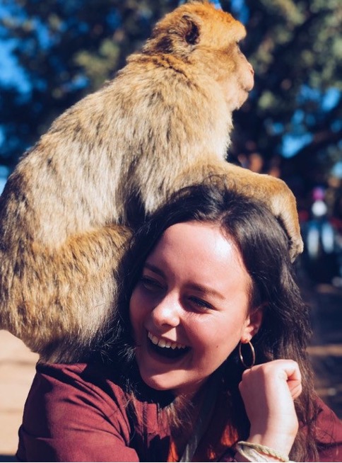 Emily Olsen poses with a monkey.