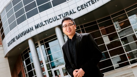 Tamayo Zhou, a master's student in Educational Administration with Student Affairs Administration specialization, stands in front of the Gaughan Multicultural Center. 