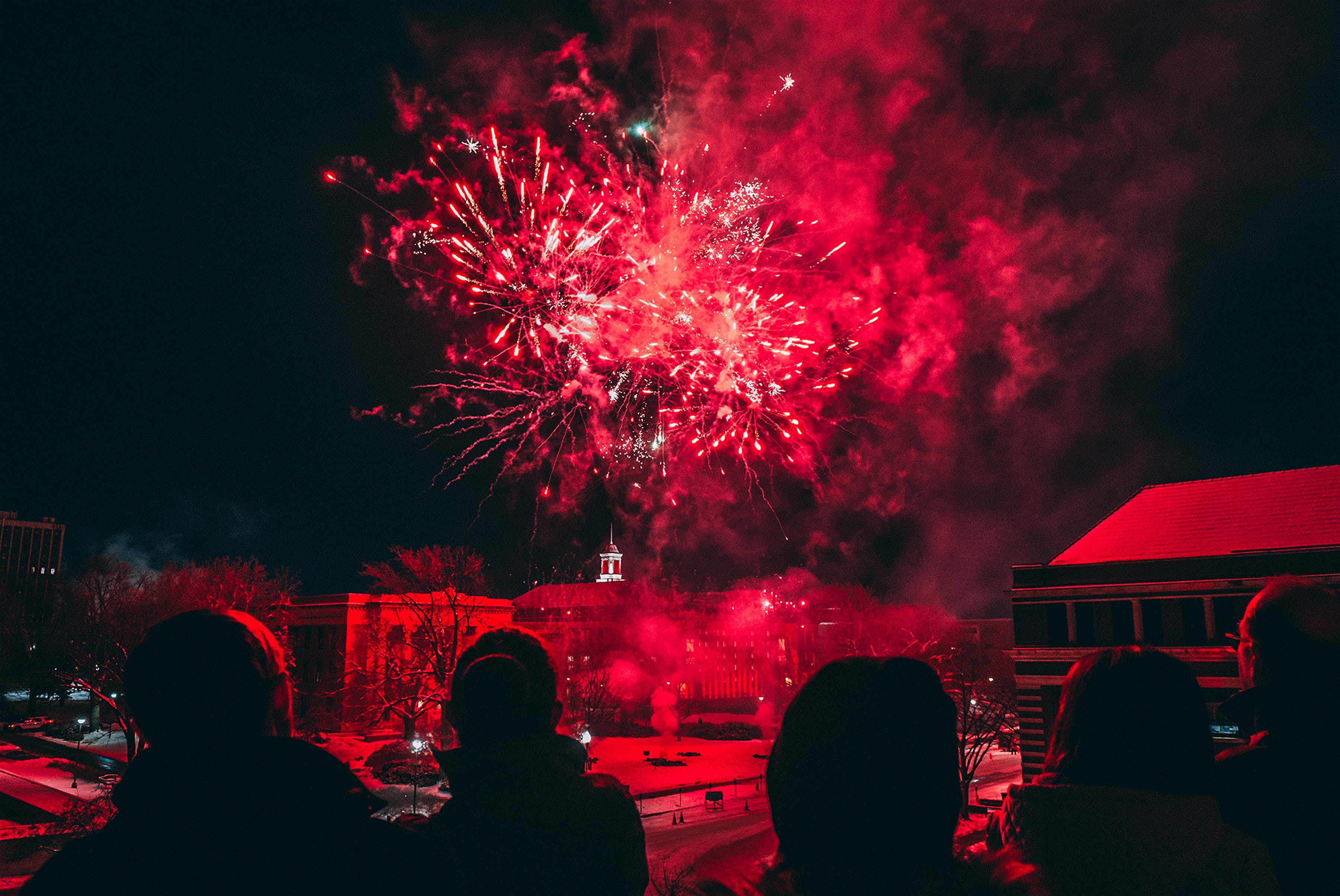 Spectators watch fireworks during Charter Week, Nebraska's 150-year celebration.