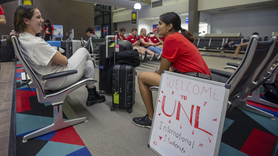 UNL student workers greet newly arrived international students at the Lincoln airport