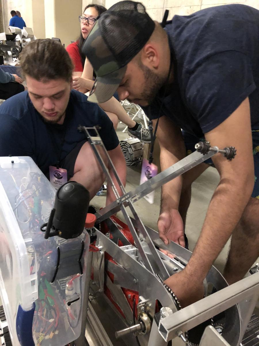 Said helping his teammate build the robot with Lunabotics