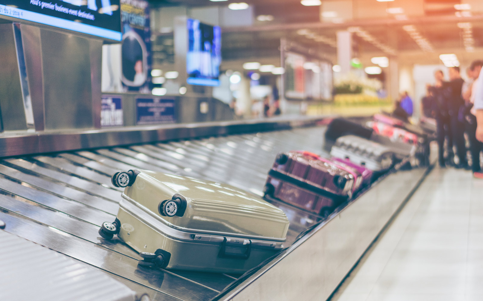 suitcases on conveyor belt in airport