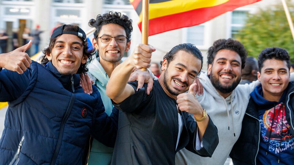 international students at parade with flags