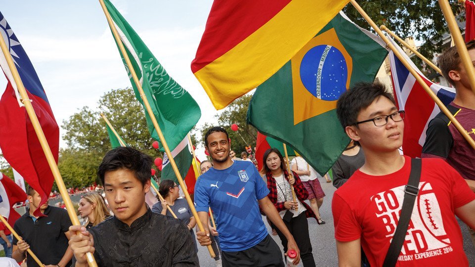 international students at parade with flags