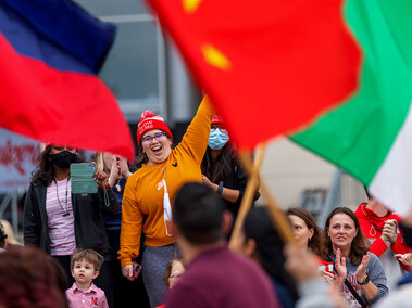 homecoming students at parade with international flags