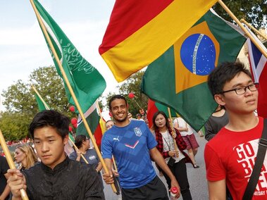 international students at parade with flags