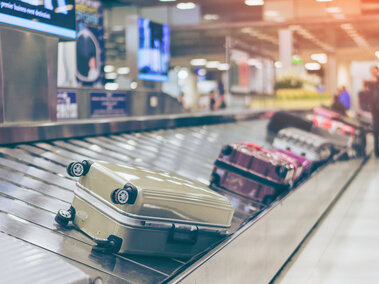 suitcases on conveyor belt in airport