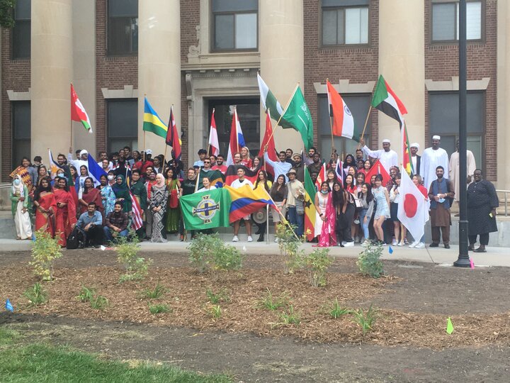 International students holding flags from their countries 