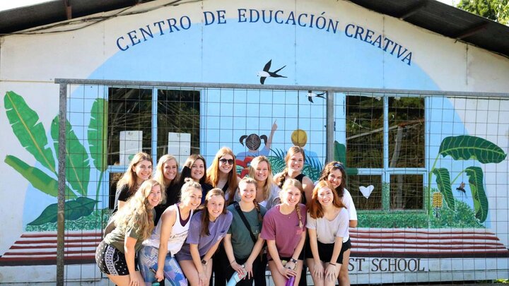 Students smiling outside of school in Costa Rica.