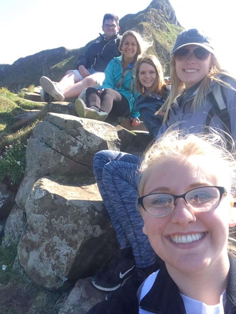 Students in Ireland posing for picture near some rocks
